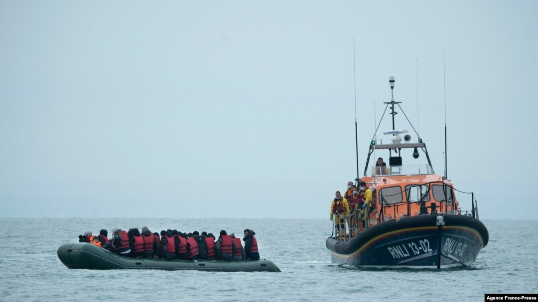 Migrants are helped by RNLI (Royal National Lifeboat Institution) lifeboat before being taken to a beach in Dungeness, on the south-east coast of England, 11.24.2021, after crossing the English Channel.
