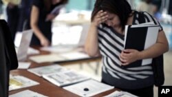 A woman browses job openings at a job fair in Los Angeles, California, (File)