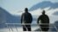 President Barack Obama, accompanied by a National Park Service employee looks at Bear Glacier, which has receded 1.8 miles in approximately 100 years, while on a boat tour to see the effects of global warming in Resurrection Cove, Sept. 1, 2015, in Seward