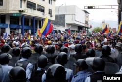 Opposition supporters clash with police during protests against unpopular leftist President Nicolas Maduro in San Cristobal, Venezuela, April 19, 2017.