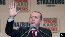 FILE - Turkey's President Recep Tayyip Erdogan gestures as he speaks to supporters of his ruling Justice and Development Party as they rally to denounce violence by Kurdish rebels, in Strasbourg, eastern France, Oct. 4, 2015. 