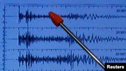 Official of Japan's earthquake agency points at graph of ground motion waveform data observed Feb. 12, 2013 from North Korean nuclear test