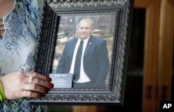 Laurie Holt holds a photo of her son during an interview at their home, June 28, 2017, in Riverton, Utah.