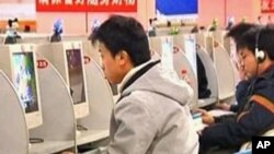 FILE - People use the Internet at a cybercafe in China.
