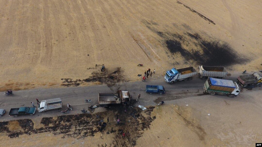 An areal picture taken on Oct. 28, 2019, shows vehicles near a destroyed truck at the spot where Abu Hassan al-Muhajir, the Islamic State (IS) group's spokesman, was reportedly killed in a raid in the Syrian village of Ayn al-Bayda near Jarablus.