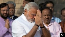 Indian Prime Minister-designate and Hindu nationalist Bharatiya Janata Party leader Narendra Modi pays his respects at Rajghat, the memorial of Mahatma Gandhi, in New Delhi, May 26, 2014.