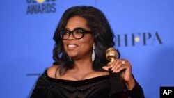 Oprah Winfrey poses in the press room with the Cecil B. DeMille Award at the 75th annual Golden Globe Awards 