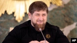 FILE - Chechen regional leader Ramzan Kadyrov speaks to journalists in Chechnya's provincial capital Grozny, Russia, Dec. 28, 2015. Kadyrov has posted a video on the Internet showing Russian opposition politician Mikhail Kasyanov in the cross-hairs of a sniper scope.