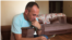 FILE - Activist Khaleel Aldakhi uses a cellphone to track down Yazidi women captured by Islamic State extremists. (S. Behn/VOA)