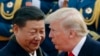 FILE - US President Donald Trump chats with Chinese President Xi Jinping during a welcome ceremony at the Great Hall of the People in Beijing on Nov. 9, 2017.