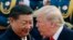 FILE - US President Donald Trump chats with Chinese President Xi Jinping during a welcome ceremony at the Great Hall of the People in Beijing on Nov. 9, 2017.