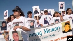 Della John, left, waits for a memorial walk Saturday, Sept. 2, 2006, west of Farmington, N.M., to honor Navajo victims of violence and discrimination in towns that border the Navajo Nation.