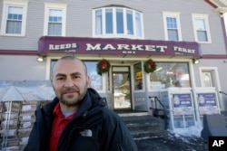 Sam Safa, of Merrimack, N.H., owner of Reeds Ferry Market, stands for a photograph outside the convenience store, Jan. 7, 2018, in Merrimack.