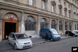 A police officer stands next to the entrance of the judicial Police headquarters, part of the Palace of Justice complex, in Paris, France, April 27, 2016.