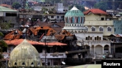Damaged buildings and houses are seen as government forces continue their assault against insurgents from the Maute group, who have taken over large parts of the Marawi City, Philippines, June 22, 2017.