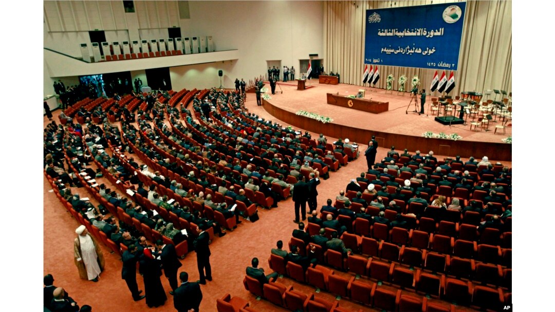 Iraqi newly elected parliament members attend the first session of parliament in the heavily fortified Green Zone in Baghdad, July 1, 2014.