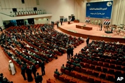 Iraqi newly elected parliament members attend the first session of parliament in the heavily fortified Green Zone in Baghdad, July 1, 2014.