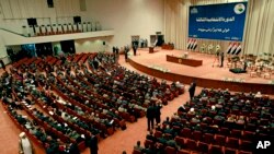 Iraqi newly elected parliament members attend the first session of parliament in the heavily fortified Green Zone in Baghdad, July 1, 2014.