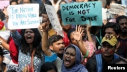 Para mahasiswa memegang plakat dan meneriakkan slogan solidaritas di Universitas Jamia Millia Islamia, Mumbai, India, 16 Desember 2019.