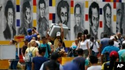 Venezuelans return to their country through the San Antonio del Tachira, Venezuela crossing, after shopping in Cucuta, Colombia, Friday, Feb. 8, 2019. 