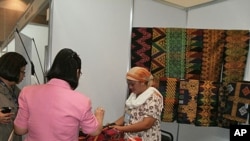 Tahanie Mohammad Dalmaob's booth of traditional "malong" dress. As a former overseas worker she qualified for a loan that payed a team of weavers to help make this clothing for special occasions.