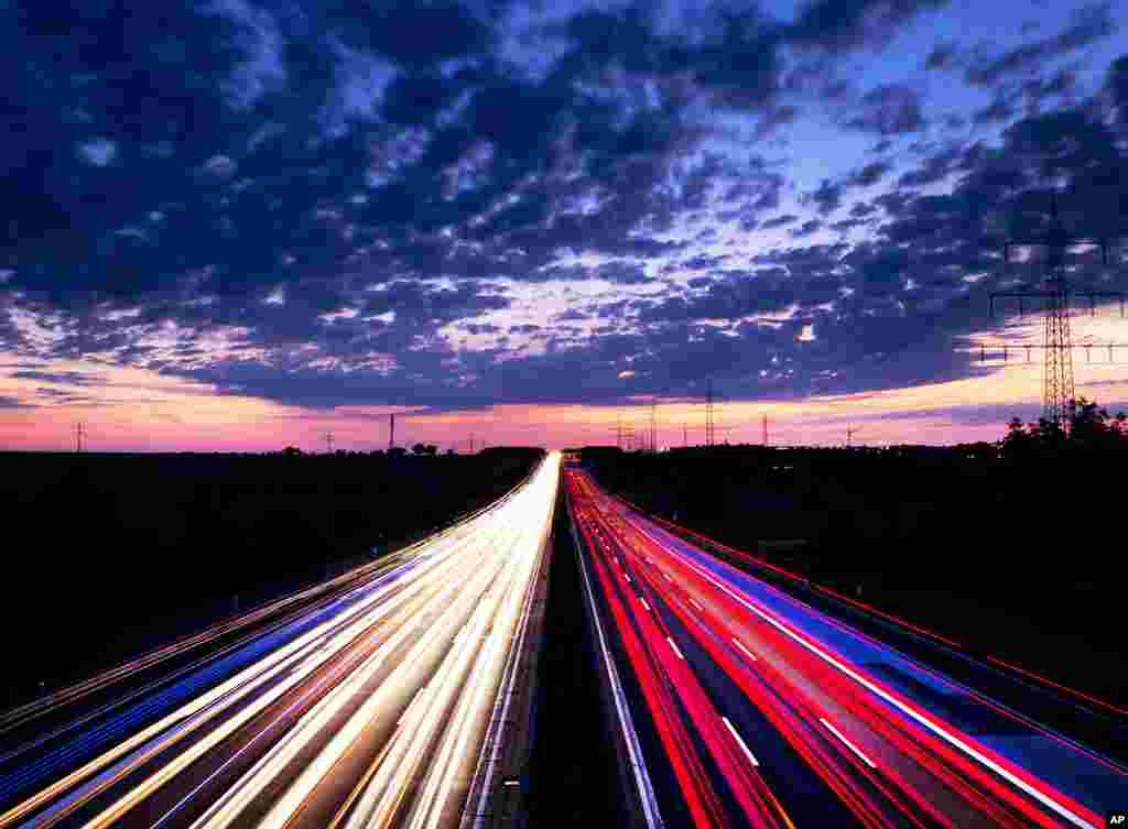 Long exposure picture shows driving cars on the highway just before sunrise near Frankfurt, central Germany.