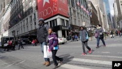 FILE - Macy's shoppers leave the retailer's flagship store in New York.