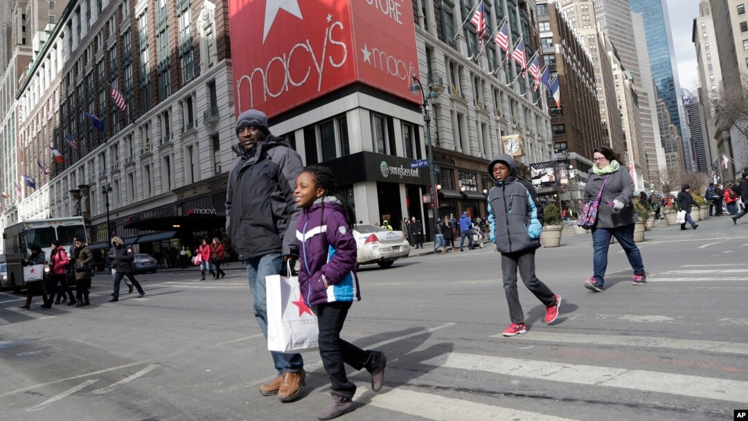 FILE - Macy's shoppers leave the retailer's flagship store in New York.