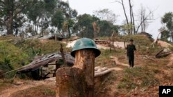 FILE - A Kachin Independence Army rebel walks at Hpalap mountain controlled by the Kachin rebels in northern Kachin state, Myanmar, March 17, 2018. The Kachin Independence Army along with other ethnic armed groups have been fighting against Myanmar army for greater autonomy.