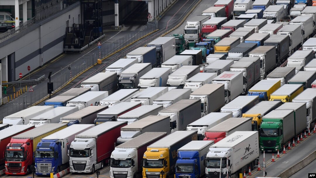Freight lorries queue as they wait to enter the port of Dover on the south coast of England, Dec. 10, 2020, before boarding a ferry to Europe. 