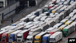 Freight lorries queue as they wait to enter the port of Dover on the south coast of England, Dec. 10, 2020, before boarding a ferry to Europe. 