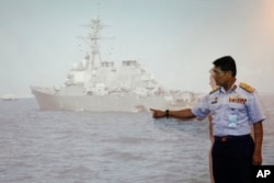 Malaysian Maritime Director Indera Abu Bakar points the damage of USS John S. McCain shown on a screen during a press conference in Putrajaya, Malaysia, Aug. 21, 2017.