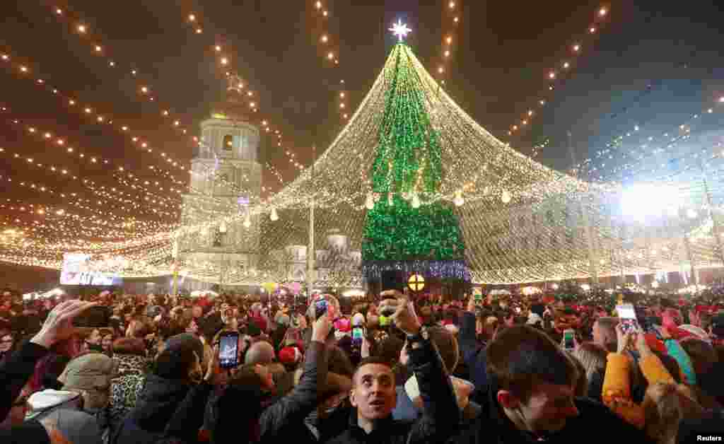 Revelers take part in New Year&#39;s Eve celebrations in Kyiv, Ukraine, Dec. 31, 2020. 