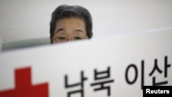 A woman who said she has family members living in North Korea waits for her turn to prepare documents for reunion at the Red Cross building in Seoul, South Korea, Sept. 8, 2015.
