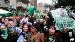 Abortion-rights activists celebrate after the Constitutional Court approved the decriminalization of abortion, lifting all limitations on the procedure until the 24th week of pregnancy, in Bogota, Colombia, Feb. 21, 2022.
