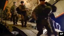 In this image taken from footage provided by the RU-RTR Russian television, Russian peacekeepers exit a Russian military near an airport in Kazakhstan, Jan. 6, 2022.