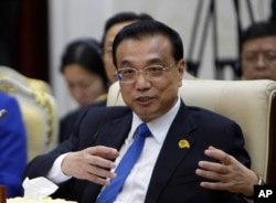 FILE - China's Premier Li Keqiang gestures during the opening of the Lancang-Mekong Cooperation forum Leaders Meeting in Phnom Penh, Cambodia, Jan. 10, 2018.