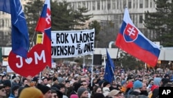 People gather in Bratislava, Slovakia on Feb. 21, 2025, to mark the seventh anniversary of the slayings of an investigative journalist, Jan Kuciak, and his fiancee, Martina Kusnirova. (Vaclav Salek/CTK via AP)