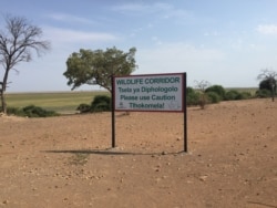 A sign shows a kilometer wide elephant corridor leading into Namibia and subsequently, Angola. (Mqondisi Dube/VOA)