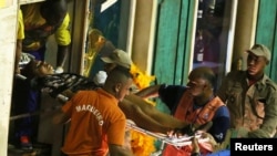 A reveler is assisted after an accident with a float from Unidos da Tijuca samba school during the second night of the carnival parade at the Sambadrome in Rio de Janeiro, Brazil, Feb. 28, 2017. 