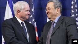 U.S. Defense Secretary Robert Gates shakes hands with Israel's Defense Minister Ehud Barak after a news conference in Tel Aviv, March 24, 2011