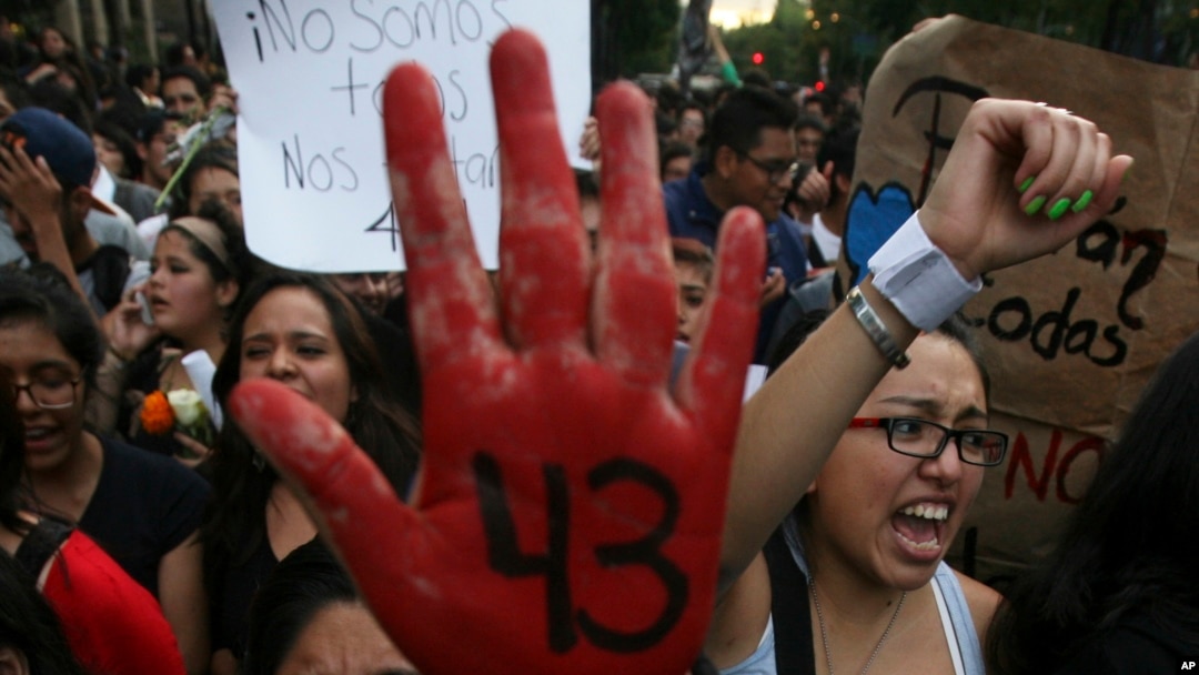 FILE - In this Oct. 22, 2014 file photo, people protest the disappearance of 43 students in Mexico City. 