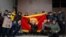 Protesters hold up a national flag at Kyrgyz government headquarters, in Bishkek, Kyrgyzstan, Oct. 6, 2020.