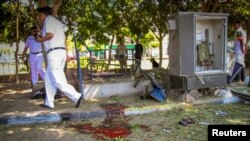 Egyptian security officials inspect a site hit by a bomb attack targeting a traffic security post near a court house in Cairo's Heliopolis district May 2, 2014. One Egyptian soldier was killed and at least seven more people wounded in two suicide attacks 