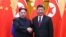 North Korean leader Kim Jong Un and Chinese President Xi Jinping shake hands