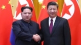 North Korean leader Kim Jong Un and Chinese President Xi Jinping shake hands at the Great Hall of the People in Beijing, China, in this picture released to Reuters on March 28, 2018.