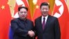 North Korean leader Kim Jong Un and Chinese President Xi Jinping shake hands at the Great Hall of the People in Beijing, China, in this picture released to Reuters on March 28, 2018.