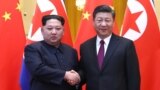 North Korean leader Kim Jong Un and Chinese President Xi Jinping shake hands at the Great Hall of the People in Beijing, China, in this picture released to Reuters on March 28, 2018.