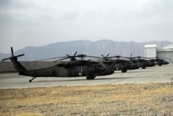 FILE - Blackhawk helicopters are seen lined up at Kandahar Airfield, Afghanistan, Jan. 23, 2018.