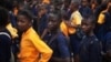 FILE - Students arrive for class at the Every Nation Academy private school in the city of Makeni in Sierra Leone.